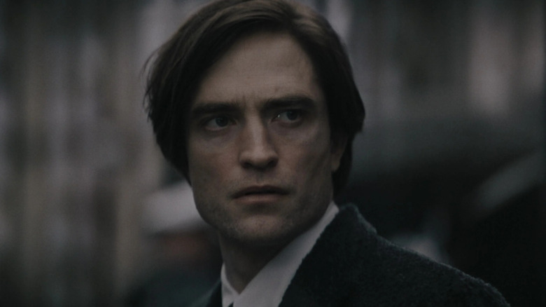 Bruce Wayne in a suit looking steely in The Batman